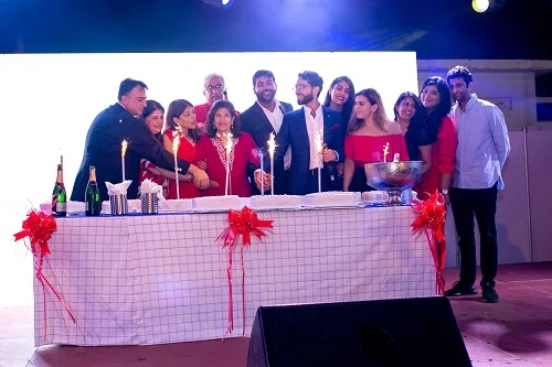 Celebration photograph accompanying Melcom’s corporate account of its September 2022 identity refresh. Individuals are not identified here.