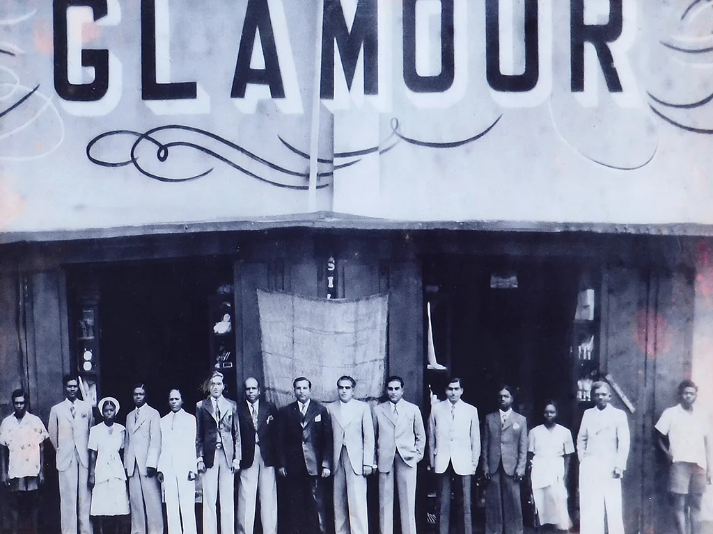 Undated Glamour storefront photograph reproduced in Melcom’s founder memoir. This is the family’s earlier business, not a Melcom opening photograph.