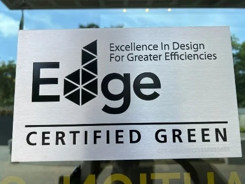 EDGE certified green signage reproduced on Melcom’s infrastructure page.