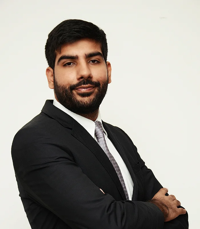 Manoj Sadhwani, listed as Group Executive Director on the reviewed corporate leadership page.